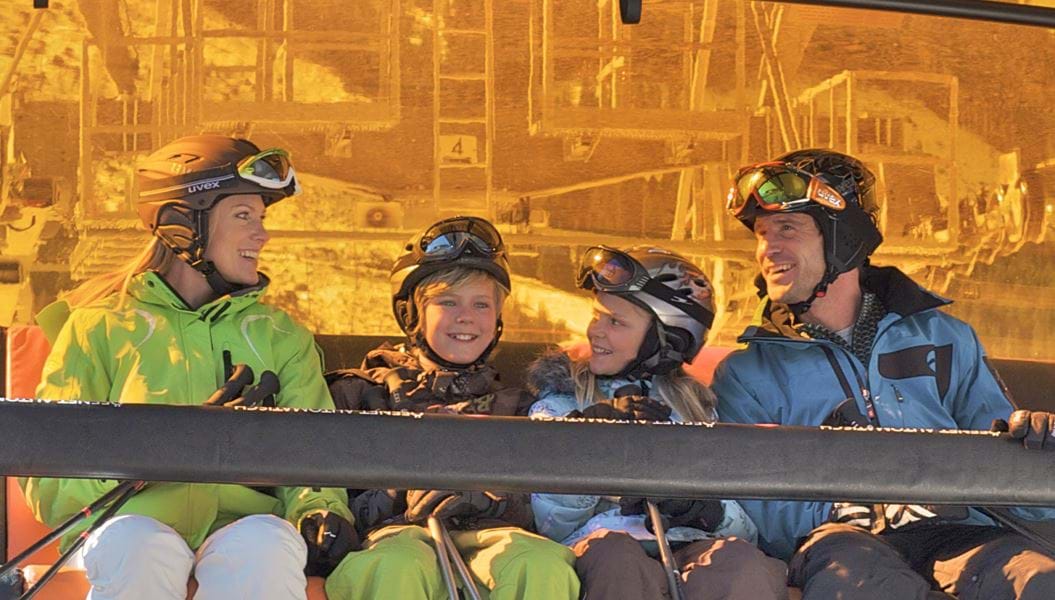Familie i orange stolelift på skiferie med Danski i Saalbach